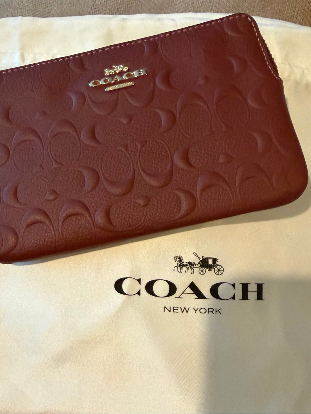 COACh Embossed Leather Clutch in Burgundy with Gold Logo
